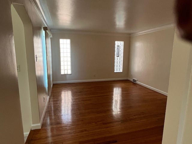 11520 Engleside St, Detroit, MI 48205 - spare room with crown molding, arched walkways, wood finished floors, and baseboards
