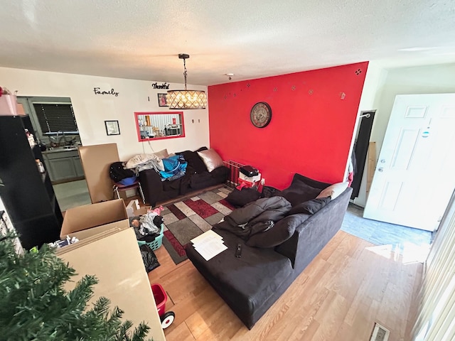 1622 Barbara Dr, Flint, MI 48504 - living room with wood finished floors, an accent wall, and a textured ceiling