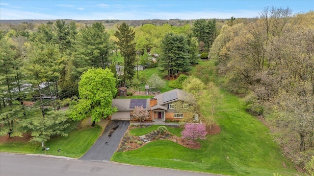 view from above of property with a heavily wooded area