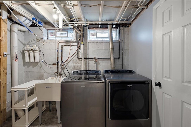 clothes washing area with washing machine and dryer
