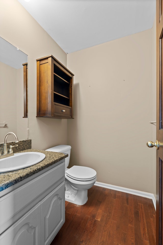 50631 Newcastle Dr, Chesterfield, MI 48047 - bathroom featuring wood finished floors, toilet, vanity, and baseboards