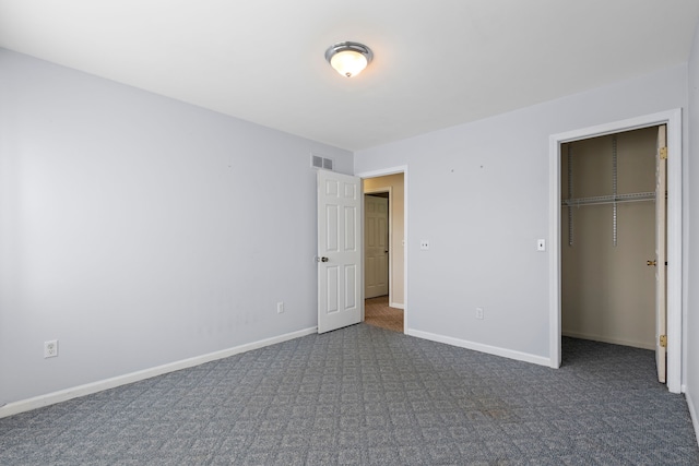 50631 Newcastle Dr, Chesterfield, MI 48047 - unfurnished bedroom with dark colored carpet, baseboards, and a spacious closet