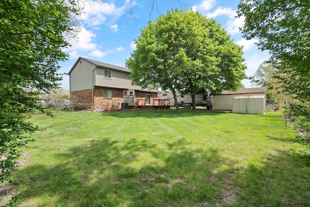 50631 Newcastle Dr, Chesterfield, MI 48047 - view of yard featuring cooling unit, an outbuilding, and a deck
