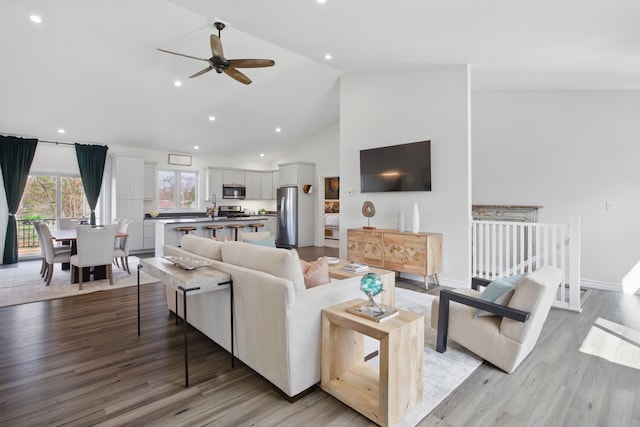 619 N Watkins, Perry, MI 48872 - living room featuring a ceiling fan, high vaulted ceiling, recessed lighting, light wood-style flooring, and baseboards