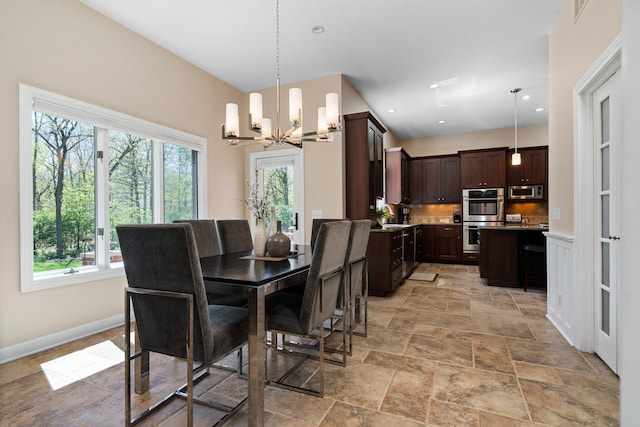 1303 Towsley Ln, Ann Arbor, MI 48105 - dining area featuring a chandelier, stone tile floors, recessed lighting, and baseboards