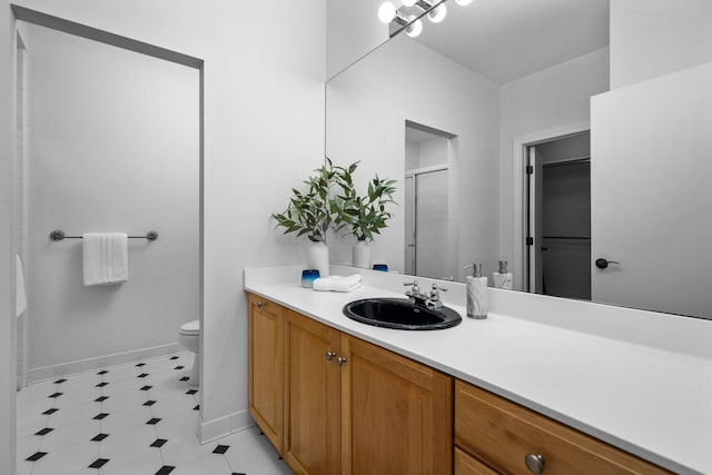 1303 Towsley Ln, Ann Arbor, MI 48105 - bathroom featuring a shower with door, vanity, baseboards, toilet, and tile patterned floors