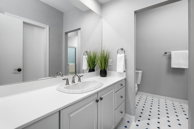 1303 Towsley Ln, Ann Arbor, MI 48105 - bathroom with toilet, vanity, baseboards, and tile patterned floors
