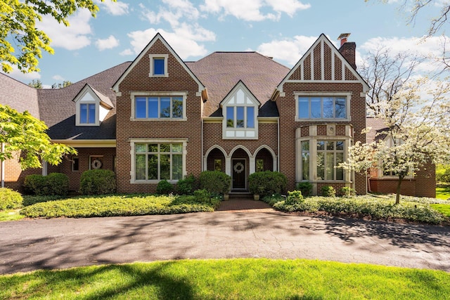1303 Towsley Ln, Ann Arbor, MI 48105 - tudor house featuring brick siding and a chimney