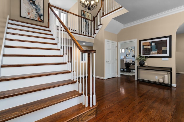 1303 Towsley Ln, Ann Arbor, MI 48105 - stairs with baseboards, arched walkways, wood finished floors, crown molding, and a chandelier