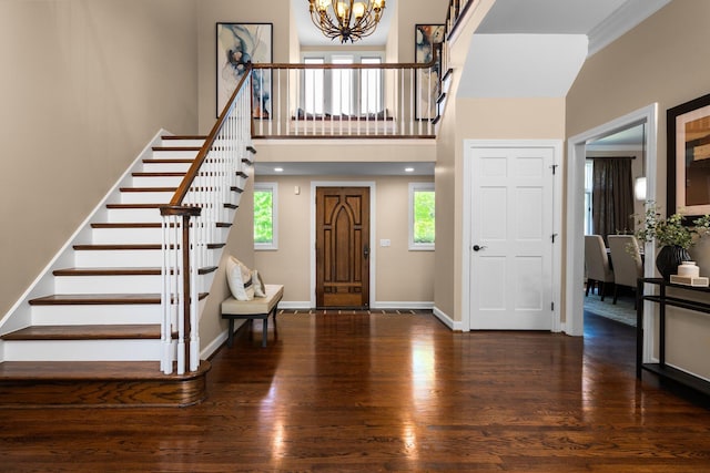 1303 Towsley Ln, Ann Arbor, MI 48105 - entrance foyer with a chandelier, wood finished floors, stairway, a towering ceiling, and baseboards