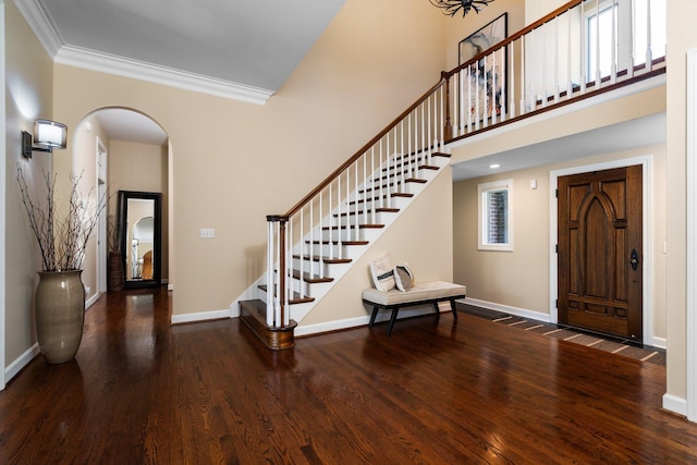 1303 Towsley Ln, Ann Arbor, MI 48105 - entrance foyer with arched walkways, wood finished floors, crown molding, baseboards, and stairway