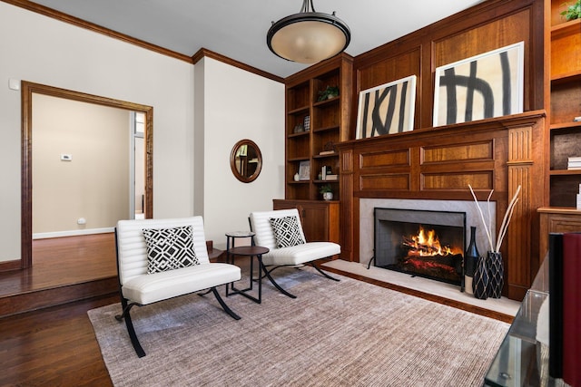 1303 Towsley Ln, Ann Arbor, MI 48105 - living area featuring crown molding, built in shelves, dark wood finished floors, a premium fireplace, and baseboards