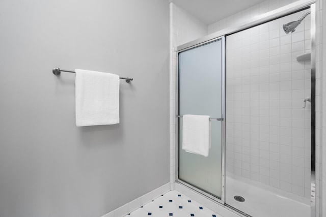 1303 Towsley Ln, Ann Arbor, MI 48105 - bathroom featuring a shower stall, baseboards, and tile patterned floors