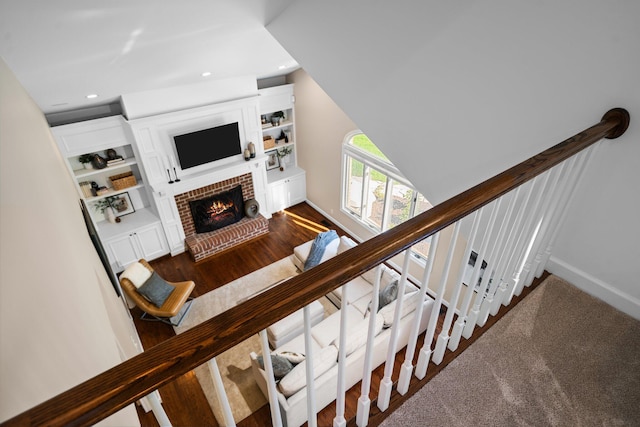 1303 Towsley Ln, Ann Arbor, MI 48105 - staircase featuring recessed lighting, a brick fireplace, baseboards, and wood finished floors