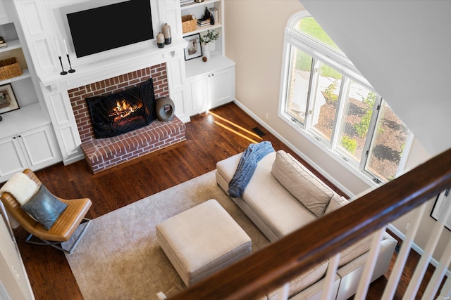 1303 Towsley Ln, Ann Arbor, MI 48105 - living room featuring dark wood-style flooring, a fireplace, and baseboards