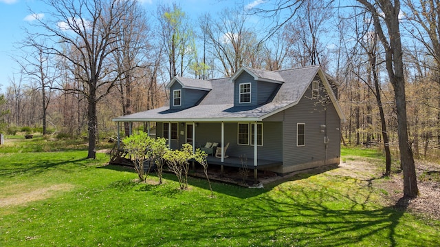 view of side of home with a yard and covered porch