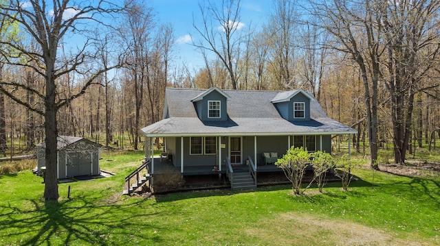 view of front of house featuring a storage shed, a porch, an outdoor structure, and a front yard
