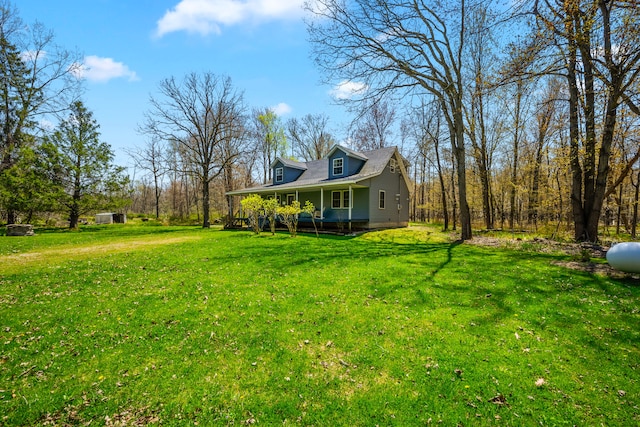 view of grassy yard with a porch