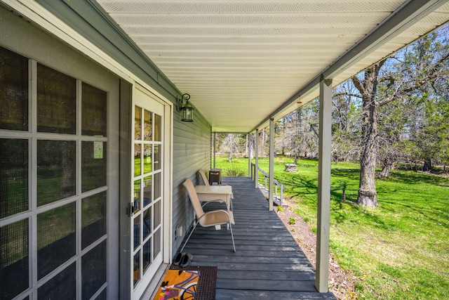 wooden terrace with a yard and a porch
