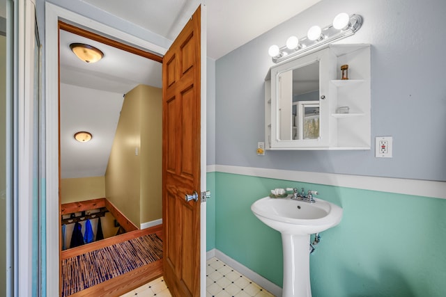 bathroom featuring tile patterned floors and a sink