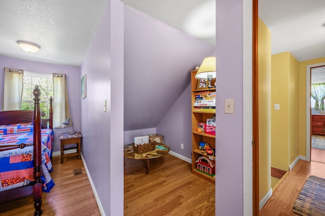 bedroom featuring wood finished floors and baseboards