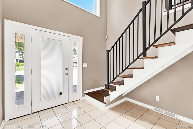 1700 Maddy Ln, Keego Harbor, MI 48320 - entryway with tile patterned floors, a towering ceiling, and stairs