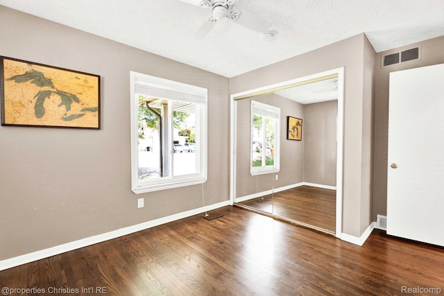 1700 Maddy Ln, Keego Harbor, MI 48320 - empty room with a ceiling fan, wood finished floors, and a textured ceiling