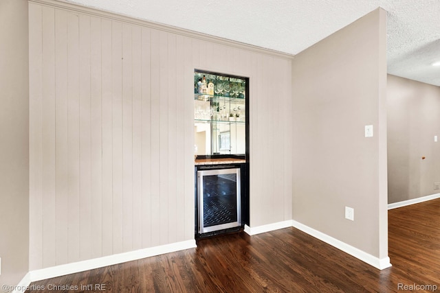 1700 Maddy Ln, Keego Harbor, MI 48320 - indoor bar featuring wine cooler, dark wood-type flooring, a textured ceiling, and wood walls