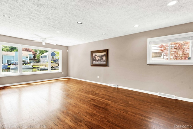 1700 Maddy Ln, Keego Harbor, MI 48320 - spare room featuring a textured ceiling, wood finished floors, recessed lighting, and a ceiling fan