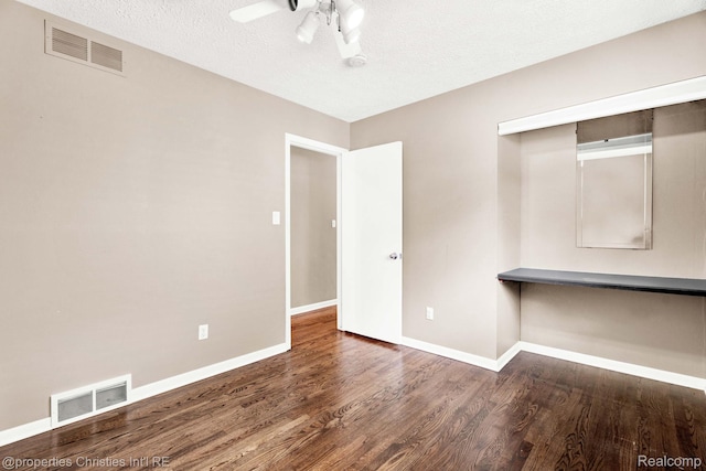 1700 Maddy Ln, Keego Harbor, MI 48320 - unfurnished room featuring wood finished floors, ceiling fan, built in study area, and a textured ceiling