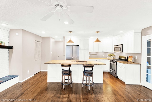 1700 Maddy Ln, Keego Harbor, MI 48320 - kitchen with appliances with stainless steel finishes, white cabinets, dark wood-style floors, and recessed lighting