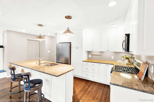 1700 Maddy Ln, Keego Harbor, MI 48320 - kitchen featuring appliances with stainless steel finishes, dark wood-style flooring, recessed lighting, white cabinetry, and light stone countertops