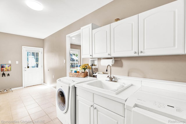1700 Maddy Ln, Keego Harbor, MI 48320 - laundry room with washing machine and dryer, light tile patterned flooring, and cabinet space