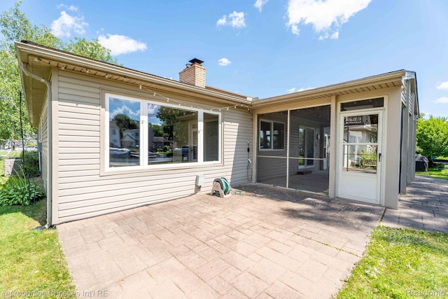 1700 Maddy Ln, Keego Harbor, MI 48320 - back of property featuring a sunroom, a patio area, and a chimney