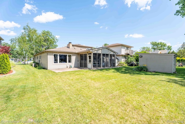 1700 Maddy Ln, Keego Harbor, MI 48320 - rear view of property featuring a sunroom, a lawn, a patio area, and a chimney