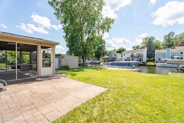 1700 Maddy Ln, Keego Harbor, MI 48320 - view of green lawn featuring a sunroom, a patio area, and a water view