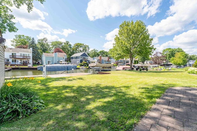 1700 Maddy Ln, Keego Harbor, MI 48320 - view of green lawn featuring a residential view, a boat dock, and a water view