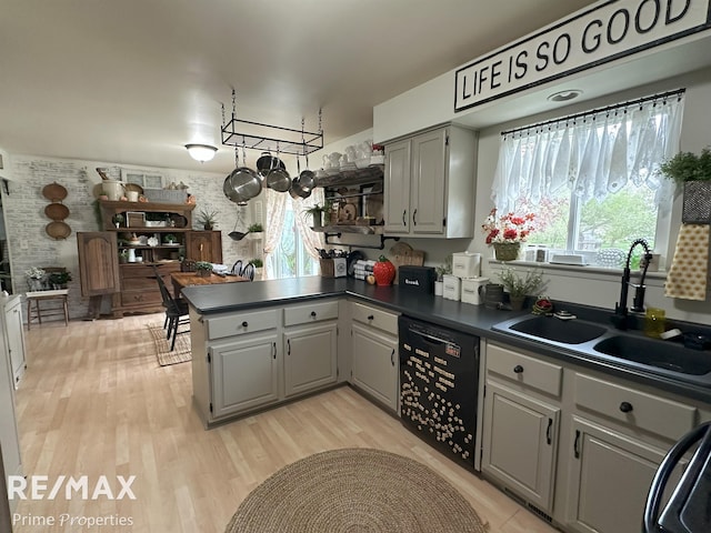 1321 Rollins St, Grand Blanc, MI 48439 - kitchen with black dishwasher, dark countertops, a peninsula, gray cabinetry, and a sink