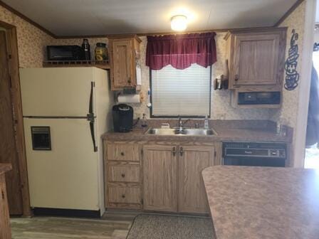 4297 N Wilderness Trl, Luther, MI 49656 - kitchen featuring freestanding refrigerator, crown molding, wallpapered walls, black dishwasher, and wood finished floors