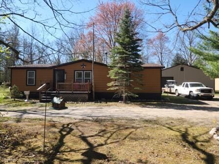 4297 N Wilderness Trl, Luther, MI 49656 - manufactured / mobile home with a deck