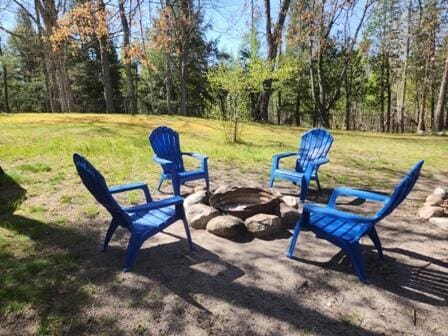 4297 N Wilderness Trl, Luther, MI 49656 - view of green lawn with a fire pit