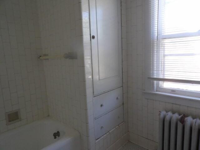 31 Orchard Pl, Battle Creek, MI 49017 - bathroom featuring radiator and bathtub / shower combination