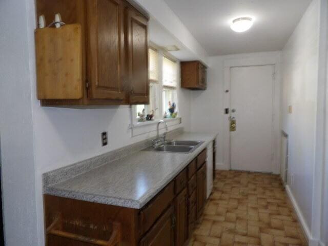 31 Orchard Pl, Battle Creek, MI 49017 - kitchen with a sink, brown cabinets, and light countertops