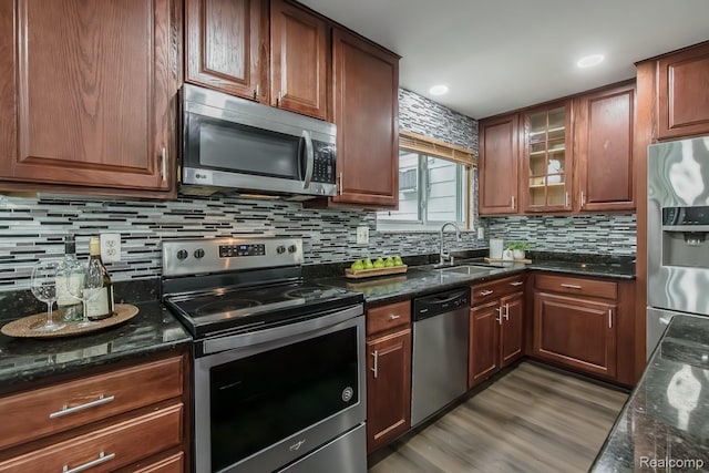 4290 Frostwood, Troy, MI 48098 - kitchen with appliances with stainless steel finishes, a sink, backsplash, and dark stone counters