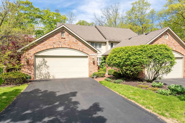 22366 Valley Oaks Dr, Beverly Hills, MI 48025 - view of front of property featuring asphalt driveway, brick siding, a shingled roof, and an attached garage