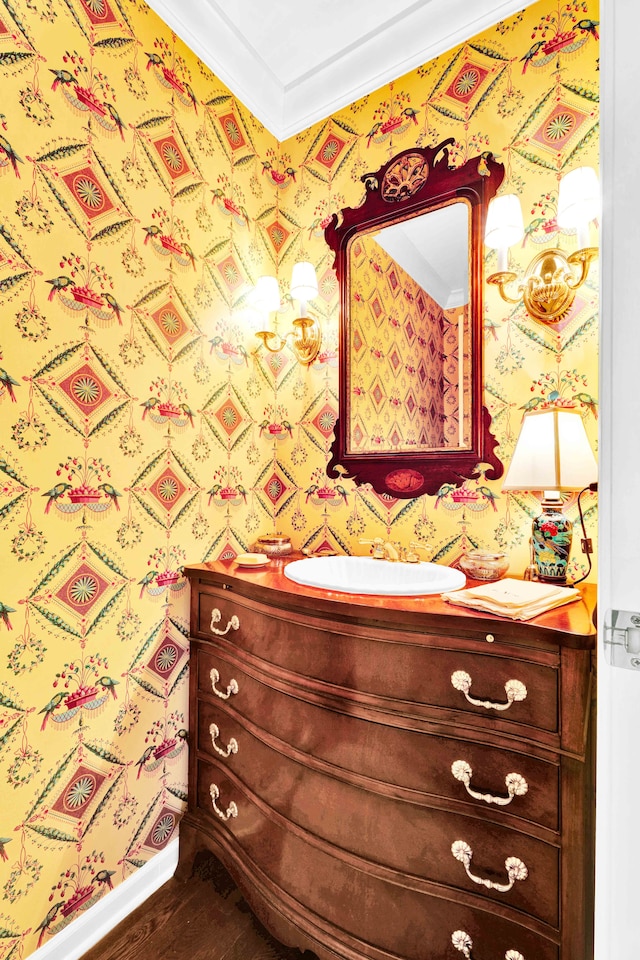 22366 Valley Oaks Dr, Beverly Hills, MI 48025 - bathroom featuring vanity, wood finished floors, wallpapered walls, and ornamental molding