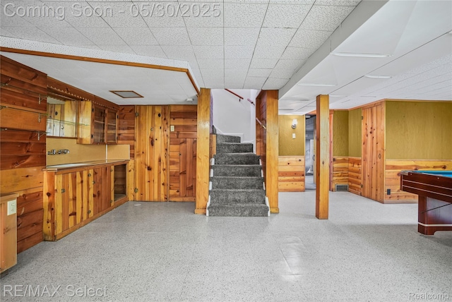 2302 Radcliffe Ave, Flint, MI 48503 - finished below grade area featuring wood walls, stairs, a paneled ceiling, and billiards table