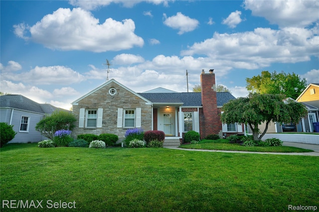 2302 Radcliffe Ave, Flint, MI 48503 - view of front facade with a chimney, stone siding, and a front lawn
