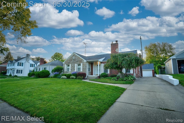 2302 Radcliffe Ave, Flint, MI 48503 - view of front of property with concrete driveway, a front yard, a garage, a chimney, and stone siding