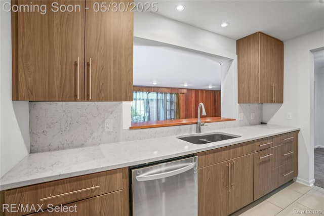 2302 Radcliffe Ave, Flint, MI 48503 - kitchen featuring stainless steel dishwasher, a sink, light stone countertops, tasteful backsplash, and light tile patterned flooring